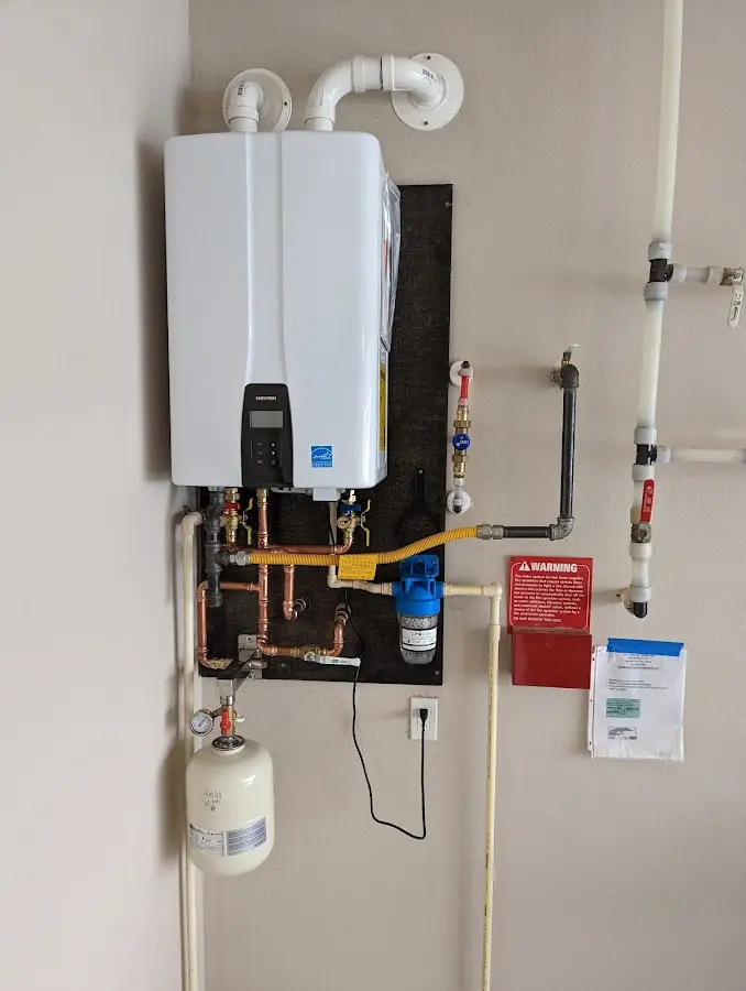 Professional plumber installing copper piping in a North Riverside home